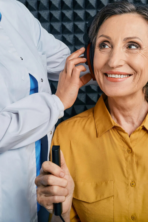 Happy Woman Receiving Hearing Tested